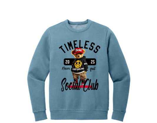 A blue crewneck sweatshirt with a graphic print of a bear and text elements, including the phrases 'Timeless' and 'Social Club'.