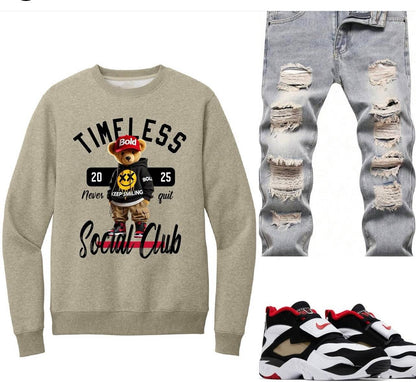 Premium sweatshirt with bear graphic, ripped jeans, and sneakers on a white background