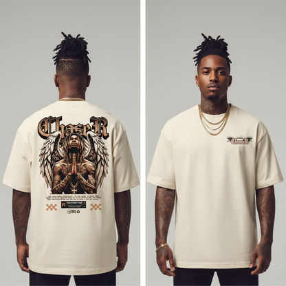 Man wearing a cream t-shirt with a graphic design on the front and back, standing against a plain background.