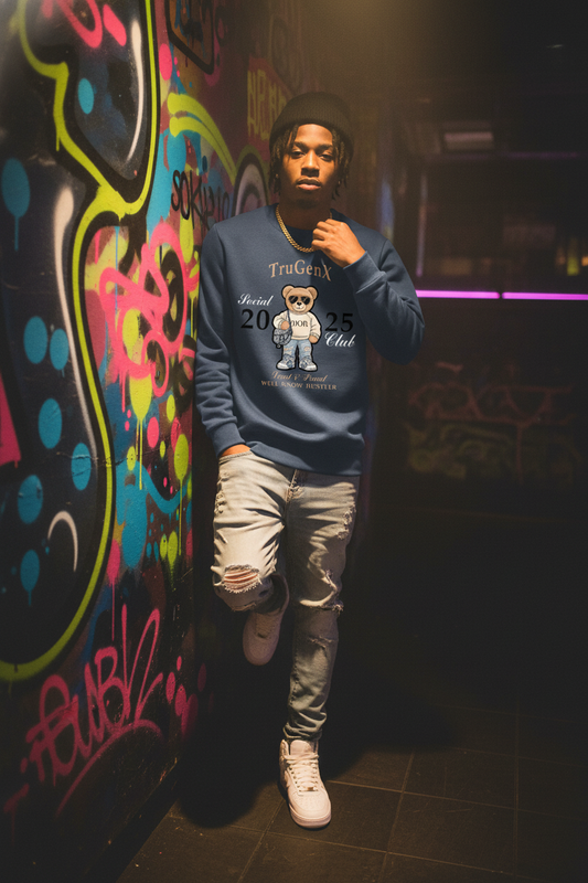 Person wearing a blue sweatshirt with graphics in front of a colorful graffiti wall.