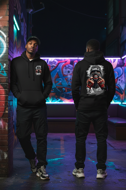 Two people wearing black hoodies with graphic designs in a neon-lit urban setting.