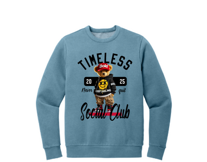 A blue crewneck sweatshirt with a graphic print of a bear and text elements, including the phrases 'Timeless' and 'Social Club'.